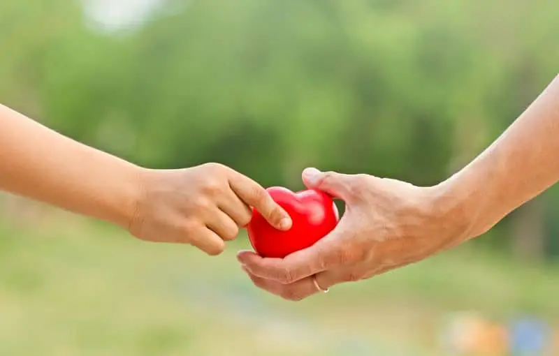 person giving heart to someone